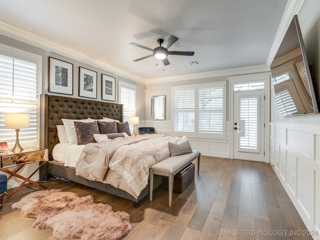 bedroom featuring crown molding, dark hardwood / wood-style floors, access to exterior, and ceiling fan