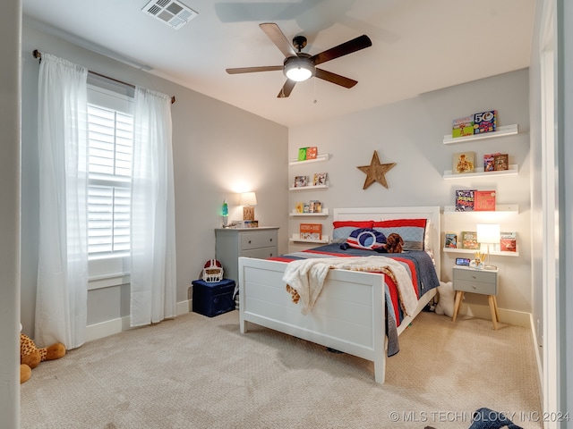 bedroom with ceiling fan and light colored carpet