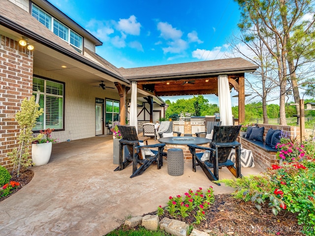 view of patio with exterior kitchen, outdoor lounge area, and ceiling fan