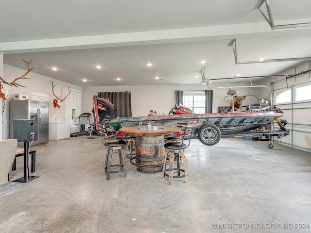 garage with stainless steel fridge