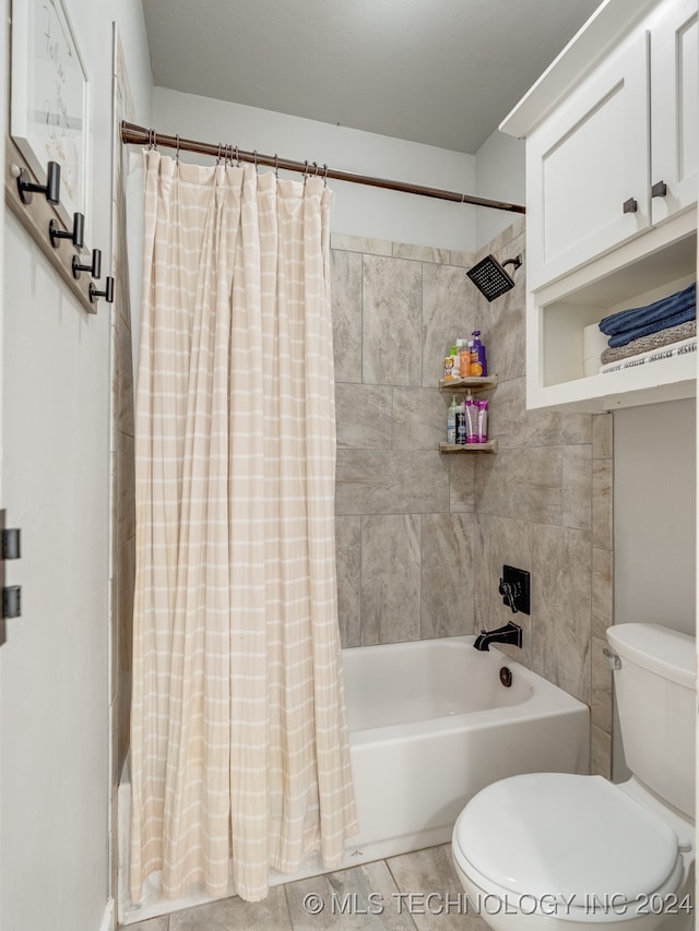 bathroom featuring toilet, tile patterned flooring, tile walls, and shower / tub combo