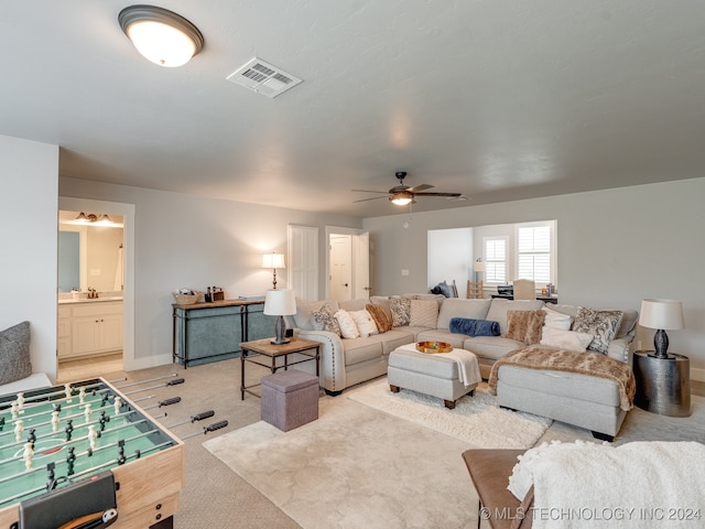 carpeted living room featuring ceiling fan