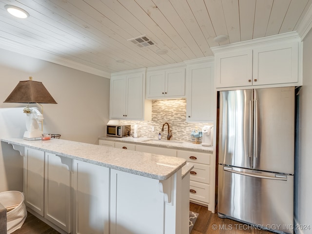 kitchen with light stone countertops, sink, appliances with stainless steel finishes, and white cabinets