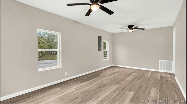 spare room with light wood-type flooring and ceiling fan