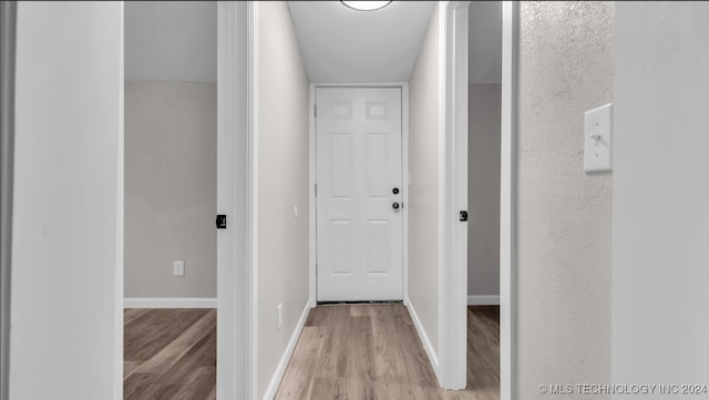 hallway with light hardwood / wood-style flooring