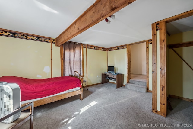 carpeted bedroom with beam ceiling