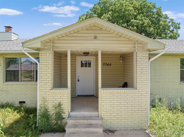 7740 Swayback, Sulphur, OK 73086 - doorway to property featuring brick siding and a shingled roof