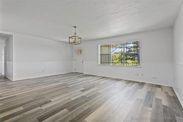 7740 Swayback, Sulphur, OK 73086 - unfurnished dining area with wood finished floors and a chandelier