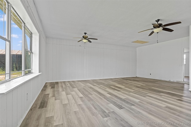 7740 Swayback, Sulphur, OK 73086 - empty room featuring a ceiling fan, light wood finished floors, and wooden walls