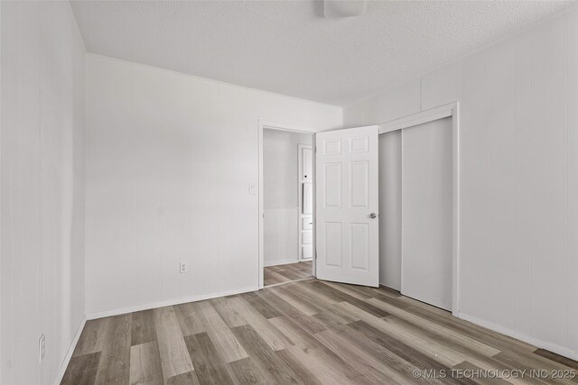 7740 Swayback, Sulphur, OK 73086 - empty room with wood finished floors and a textured ceiling