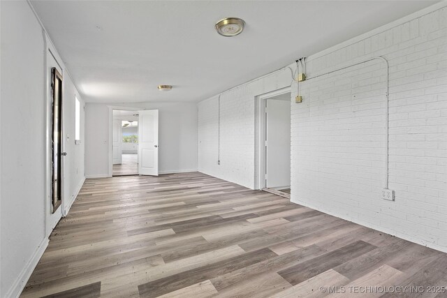 7740 Swayback, Sulphur, OK 73086 - spare room with brick wall and light wood-type flooring