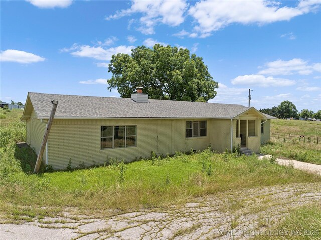 7740 Swayback, Sulphur, OK 73086 - view of front of home with brick siding, a chimney, and roof with shingles