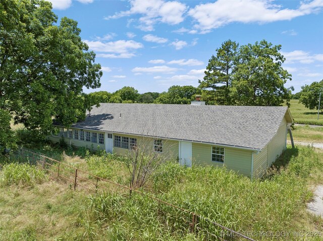 7740 Swayback, Sulphur, OK 73086 - view of side of property featuring roof with shingles and a chimney