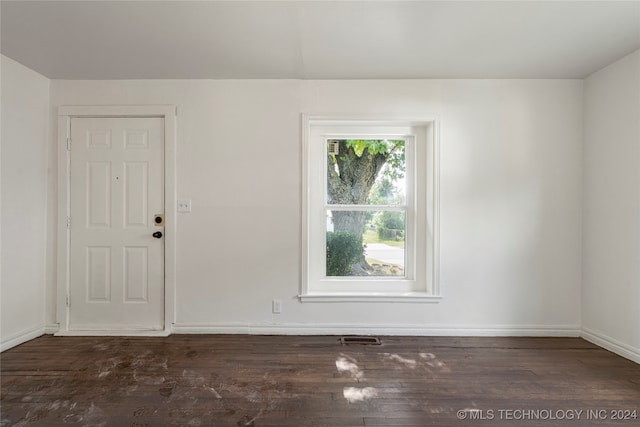 unfurnished room with dark hardwood / wood-style floors