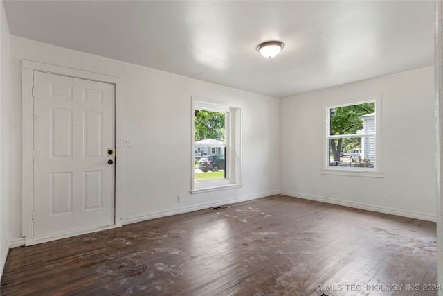 interior space with dark wood-type flooring and a healthy amount of sunlight