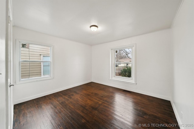 spare room with dark hardwood / wood-style floors