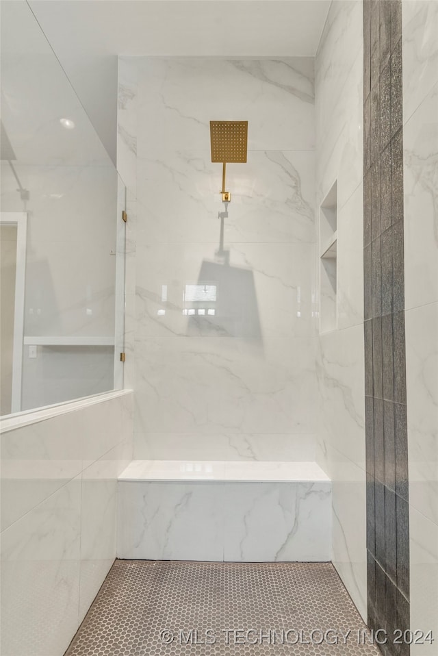 bathroom with a tile shower