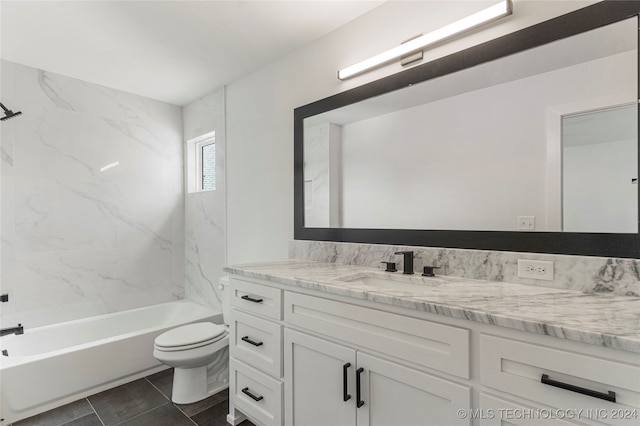 full bathroom featuring vanity, tiled shower / bath, toilet, and tile patterned floors