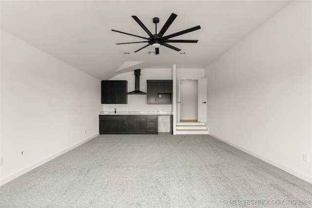 unfurnished living room with lofted ceiling, carpet floors, and ceiling fan