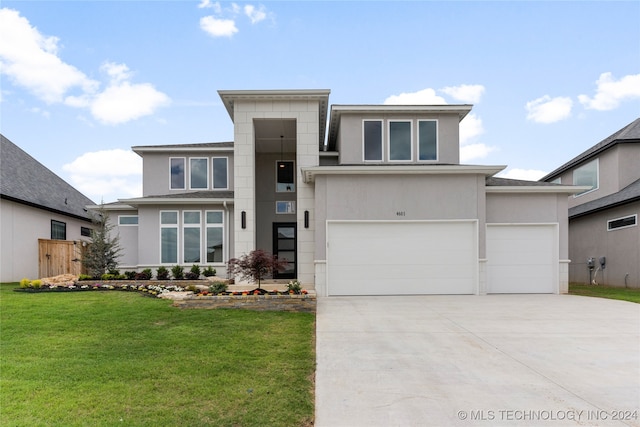 view of front of property with a garage and a front lawn