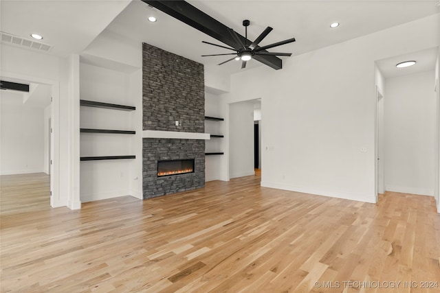 unfurnished living room with a fireplace, light wood-type flooring, and ceiling fan