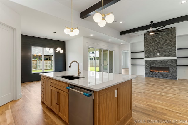 kitchen with sink, dishwasher, a kitchen island with sink, and plenty of natural light