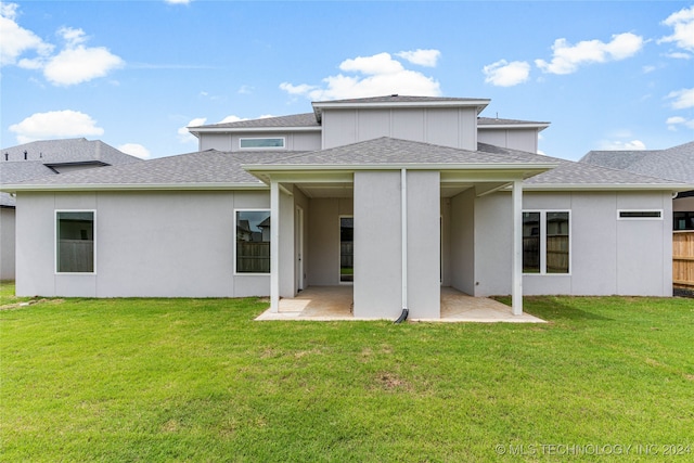 rear view of property featuring a patio area and a lawn