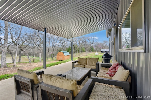 view of patio featuring outdoor lounge area and a storage unit