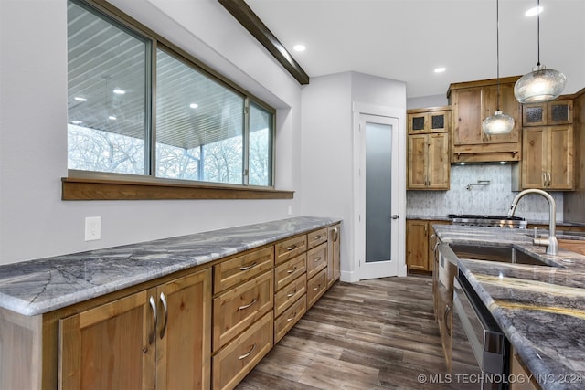 kitchen with dark stone counters, backsplash, dark wood-type flooring, pendant lighting, and dishwasher