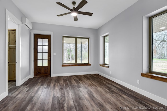 interior space with a wall unit AC, plenty of natural light, ceiling fan, and dark hardwood / wood-style flooring