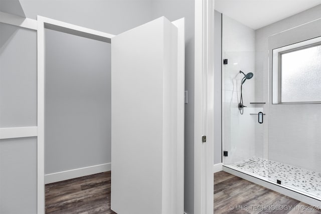 bathroom featuring walk in shower and hardwood / wood-style floors