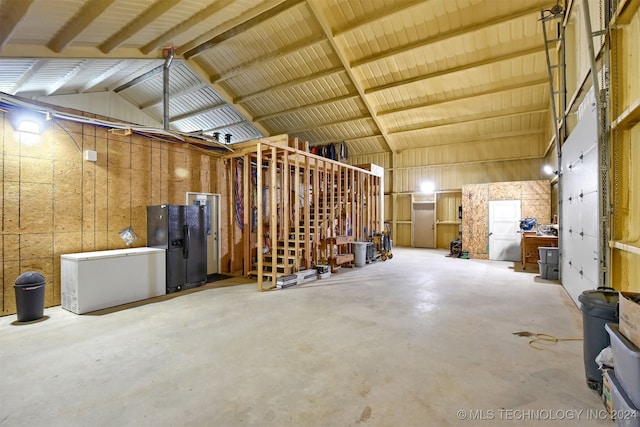 misc room with high vaulted ceiling and concrete floors