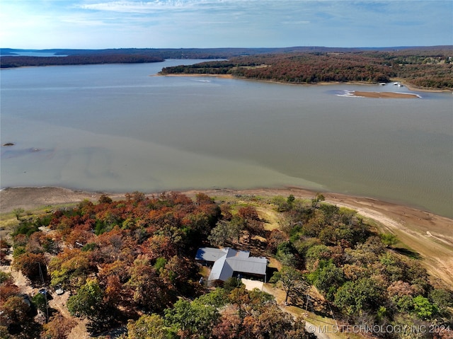 aerial view featuring a water view and a wooded view