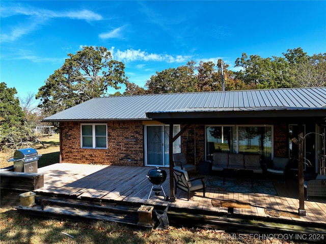 rear view of house featuring outdoor lounge area and a deck