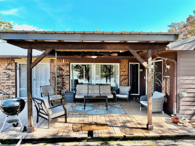 deck with an outdoor hangout area and a grill