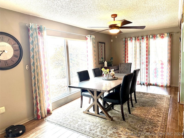 dining space with hardwood / wood-style floors, a healthy amount of sunlight, and ceiling fan