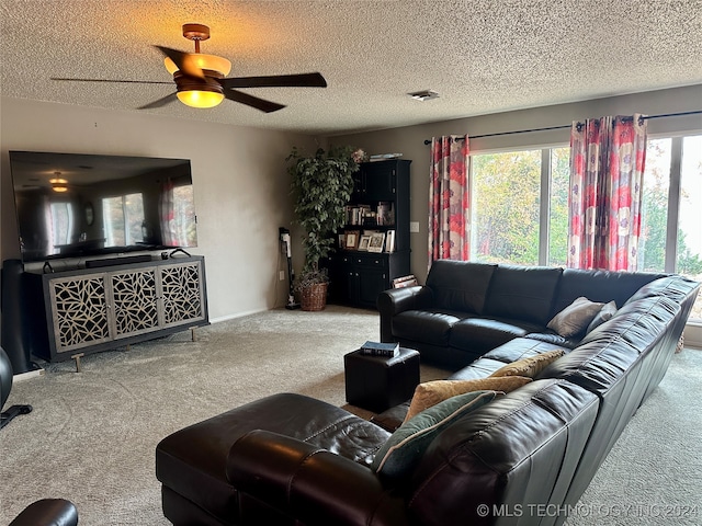 carpeted living room with a textured ceiling and ceiling fan