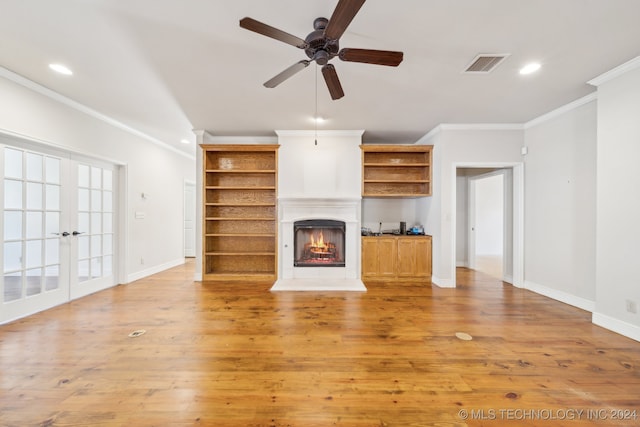 unfurnished living room featuring crown molding, light wood-type flooring, and ceiling fan