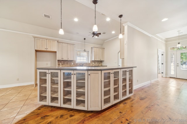 kitchen featuring a wealth of natural light, cream cabinets, light wood-type flooring, and ceiling fan