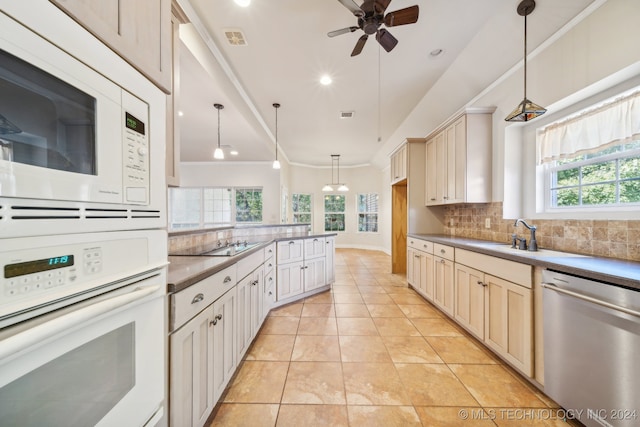 kitchen with white appliances, sink, backsplash, decorative light fixtures, and ornamental molding