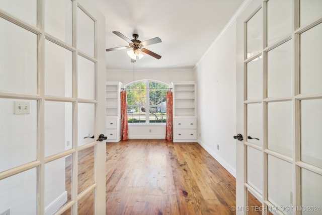 unfurnished room with light hardwood / wood-style floors, french doors, ornamental molding, and ceiling fan