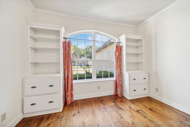 interior space with ornamental molding and light wood-type flooring