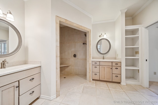 bathroom featuring vanity, crown molding, tiled shower, and tile patterned flooring