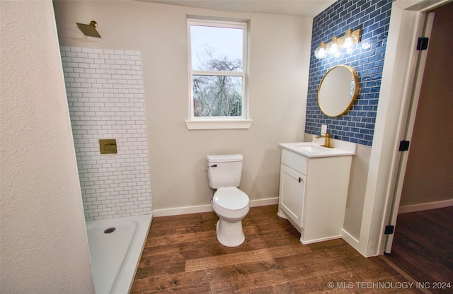 full bathroom with vanity, hardwood / wood-style flooring, toilet, and washtub / shower combination