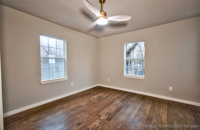 empty room featuring dark hardwood / wood-style floors and ceiling fan