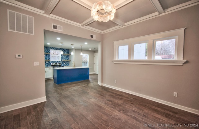 kitchen featuring dark hardwood / wood-style flooring, white cabinetry, coffered ceiling, decorative light fixtures, and a center island with sink