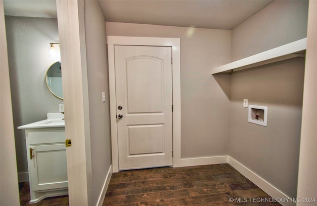 washroom featuring hookup for a washing machine and dark hardwood / wood-style floors