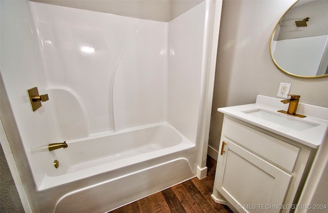 bathroom featuring vanity, wood-type flooring, and shower / tub combination