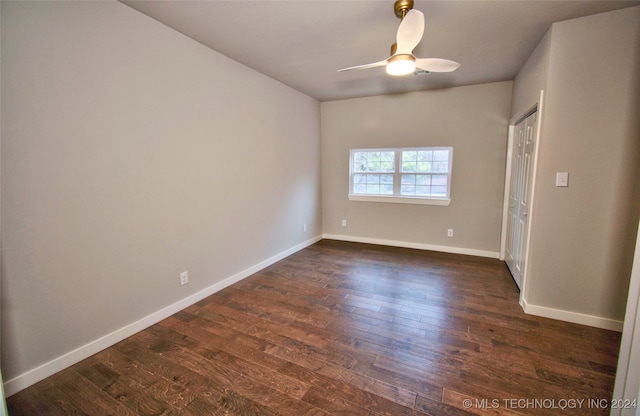 spare room with ceiling fan and dark hardwood / wood-style floors