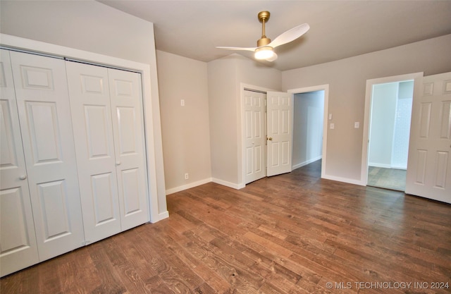 unfurnished bedroom featuring dark hardwood / wood-style flooring and ceiling fan